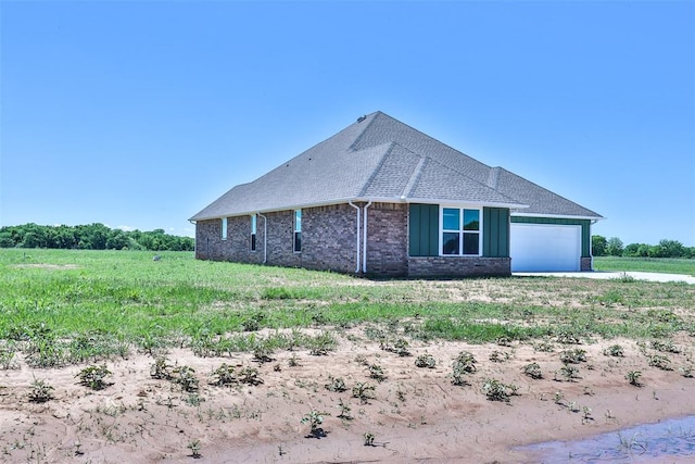 view of property exterior featuring a rural view and a garage