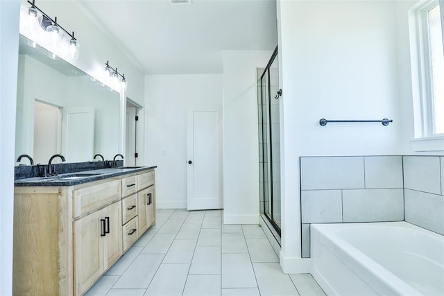 bathroom with tile patterned floors, plenty of natural light, shower with separate bathtub, and vanity