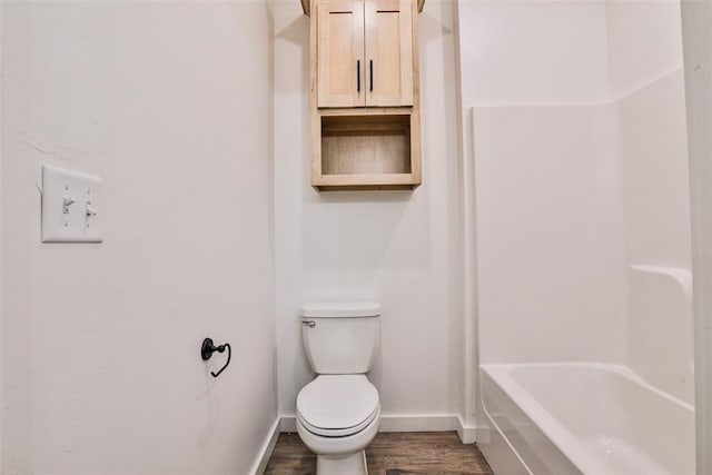 bathroom with shower with separate bathtub, hardwood / wood-style flooring, and toilet