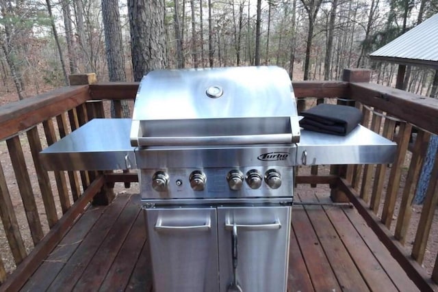 wooden terrace featuring area for grilling