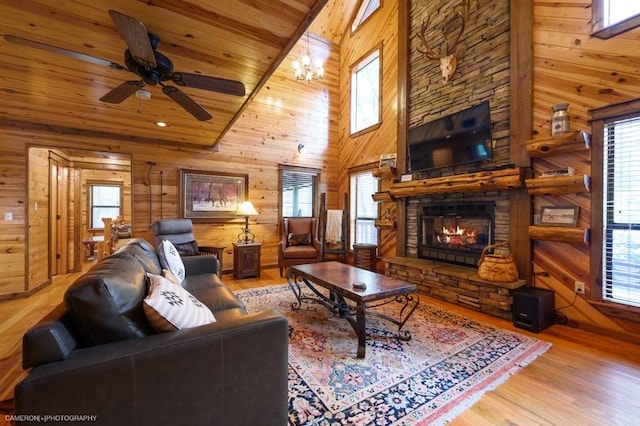 living room with hardwood / wood-style floors, high vaulted ceiling, and a healthy amount of sunlight