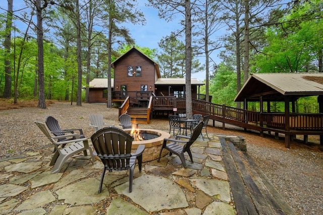 view of patio featuring a fire pit and a deck