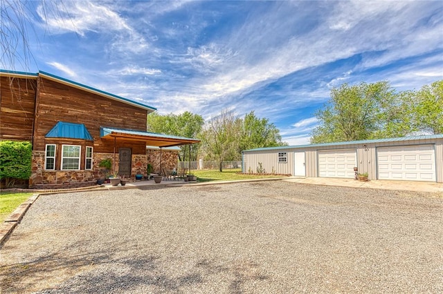 view of front of property featuring an outdoor structure and a garage