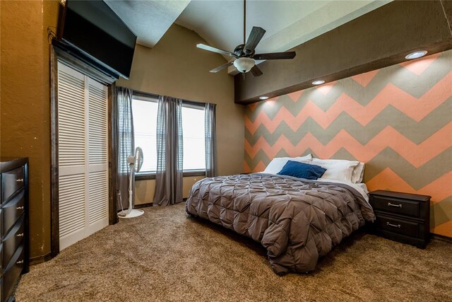 bedroom featuring carpet, ceiling fan, vaulted ceiling, and a closet