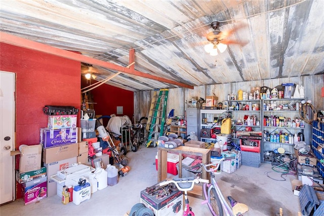 interior space featuring ceiling fan, concrete floors, and vaulted ceiling