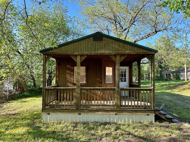 wooden deck with covered porch and a yard