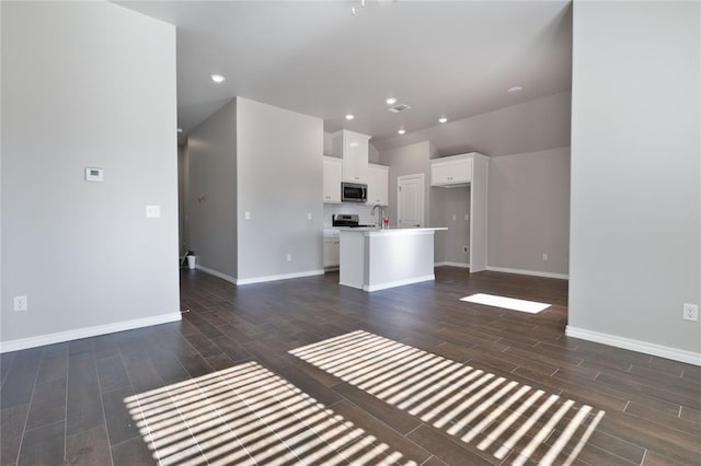 unfurnished living room featuring sink