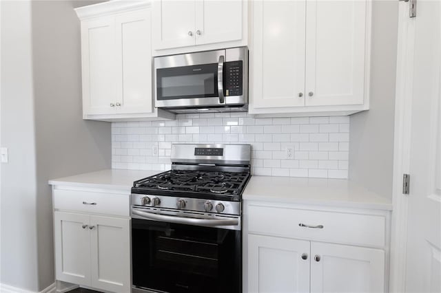 kitchen featuring appliances with stainless steel finishes, backsplash, and white cabinetry