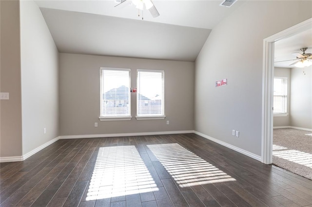 empty room with dark hardwood / wood-style flooring, ceiling fan, and lofted ceiling