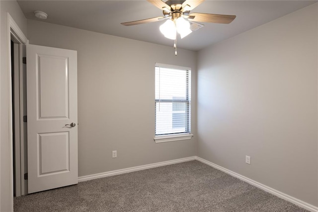 carpeted spare room featuring ceiling fan