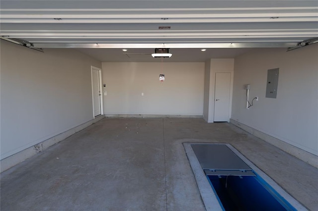 garage with electric panel and a garage door opener