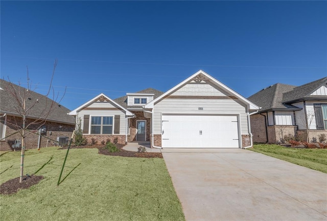 craftsman house with central AC unit, a garage, and a front lawn