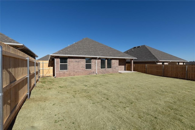 rear view of house featuring a yard