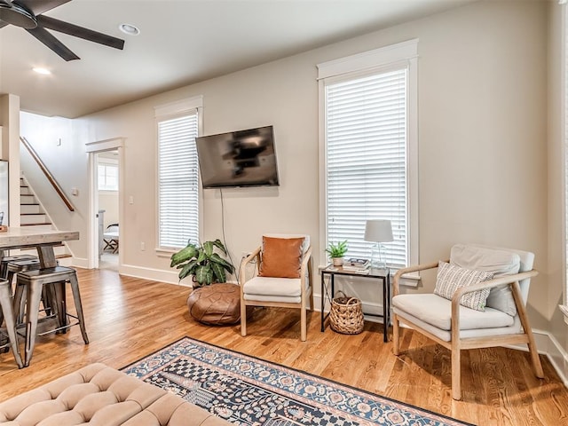 sitting room with ceiling fan, hardwood / wood-style floors, and a healthy amount of sunlight