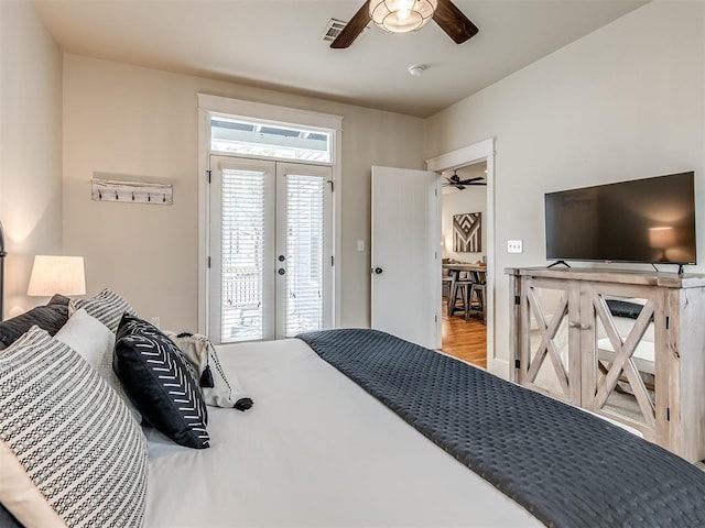 bedroom with access to exterior, ceiling fan, french doors, and wood-type flooring