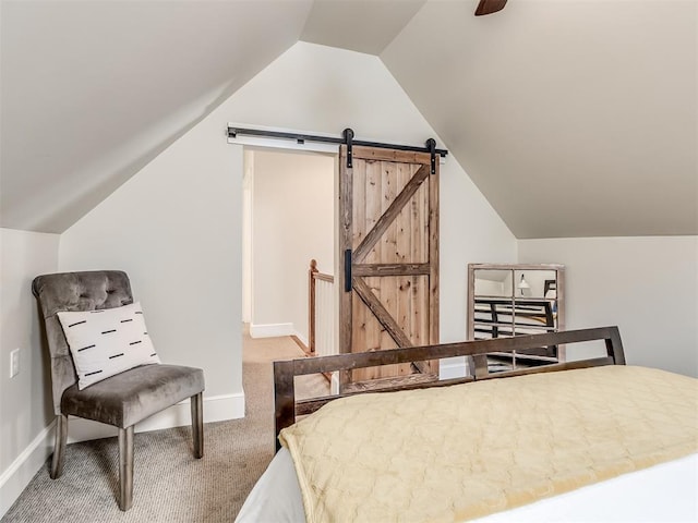 carpeted bedroom with a barn door, ceiling fan, and lofted ceiling