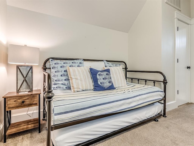 carpeted bedroom with vaulted ceiling