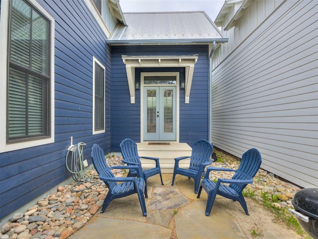 view of exterior entry with a patio area