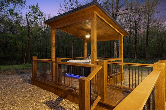 deck at dusk with a jacuzzi