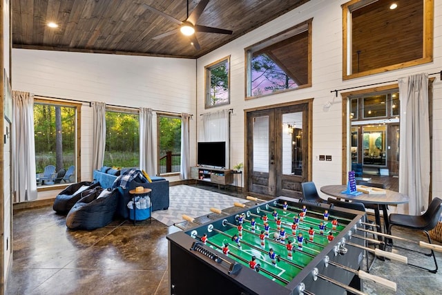 recreation room featuring ceiling fan, wooden ceiling, high vaulted ceiling, and french doors