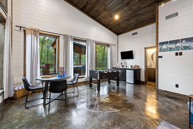 interior space featuring sink, high vaulted ceiling, wood walls, and wood ceiling