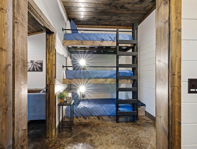 bedroom featuring wood walls and wooden ceiling