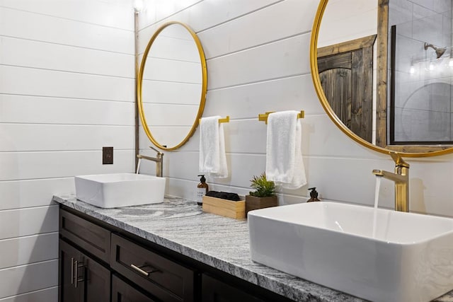 bathroom with vanity and wooden walls