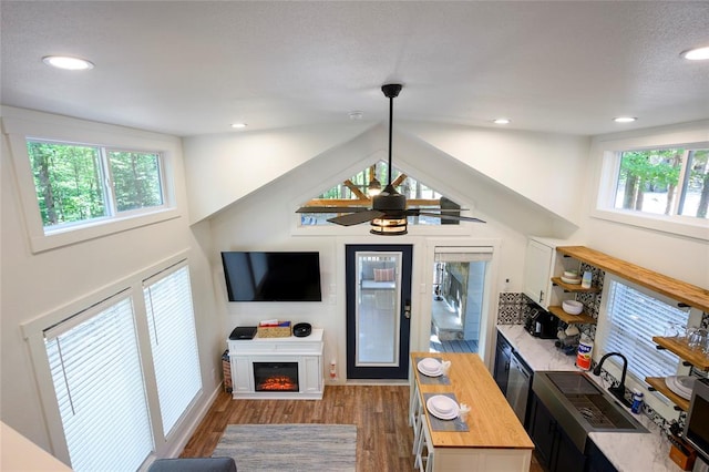 bar with dark hardwood / wood-style flooring, ceiling fan, sink, butcher block counters, and lofted ceiling