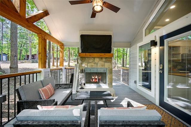 view of patio / terrace with ceiling fan and an outdoor stone fireplace