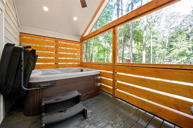 sunroom / solarium featuring lofted ceiling and a hot tub