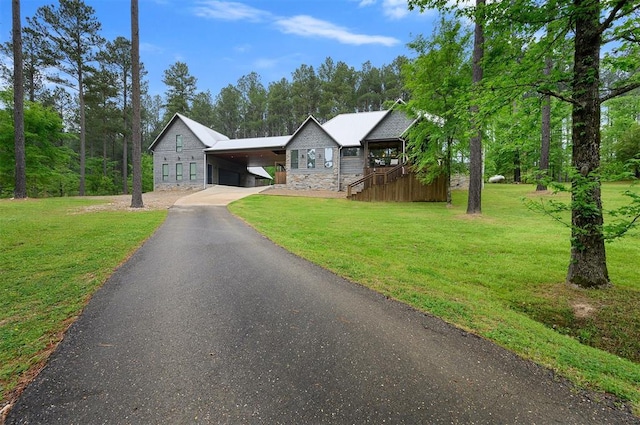 view of front of property with a front yard and a carport