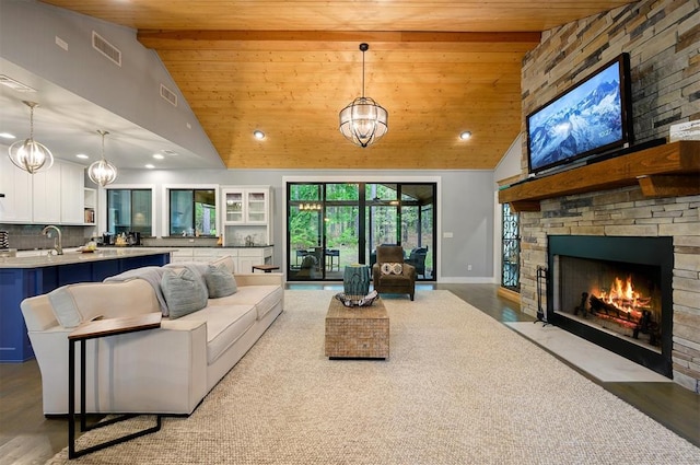 living room with light hardwood / wood-style floors, wood ceiling, and high vaulted ceiling