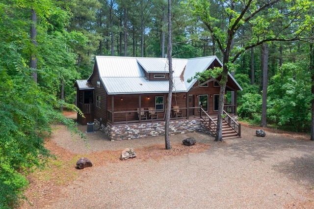 152 Ita Hina Trl, Broken Bow, OK 74728 - view of front facade featuring covered porch, metal roof, and a wooded view