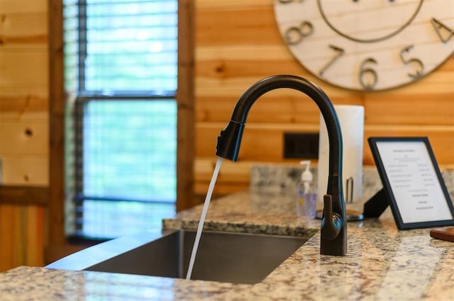 details with light stone countertops and sink