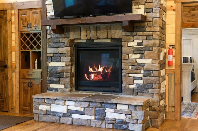 152 Ita Hina Trl, Broken Bow, OK 74728 - detailed view of wood finished floors, a fire extinguisher, a fireplace, and wood walls