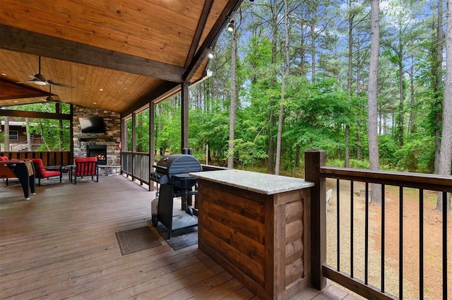152 Ita Hina Trl, Broken Bow, OK 74728 - wooden deck with an outdoor stone fireplace, a ceiling fan, and area for grilling