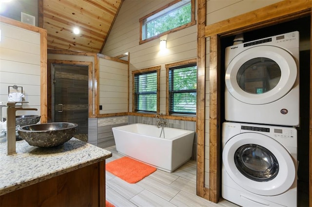 152 Ita Hina Trl, Broken Bow, OK 74728 - washroom with stacked washer / dryer, wooden walls, wood ceiling, and light wood-type flooring