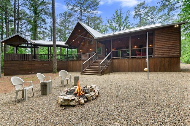 152 Ita Hina Trl, Broken Bow, OK 74728 - rear view of property featuring an outdoor fire pit, log veneer siding, ceiling fan, and stairway