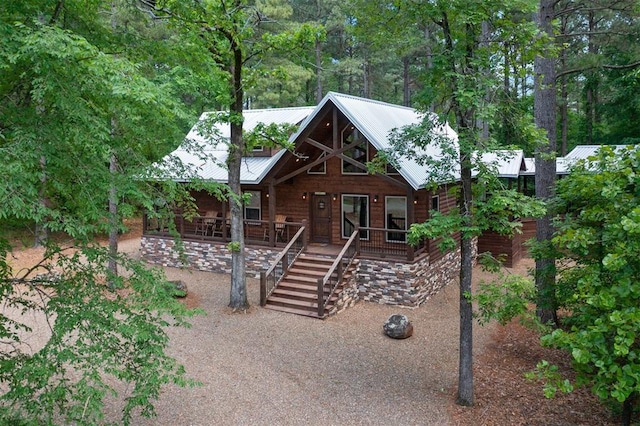 log-style house featuring covered porch