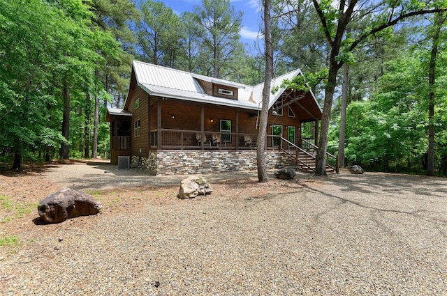 view of front of home featuring cooling unit and covered porch