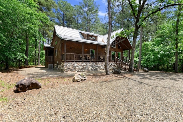 152 Ita Hina Trl, Broken Bow, OK 74728 - view of front of house featuring covered porch, cooling unit, and metal roof