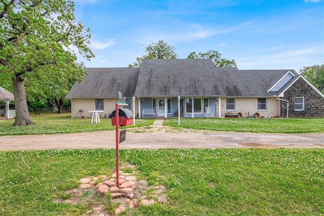 ranch-style home featuring a front yard and a porch