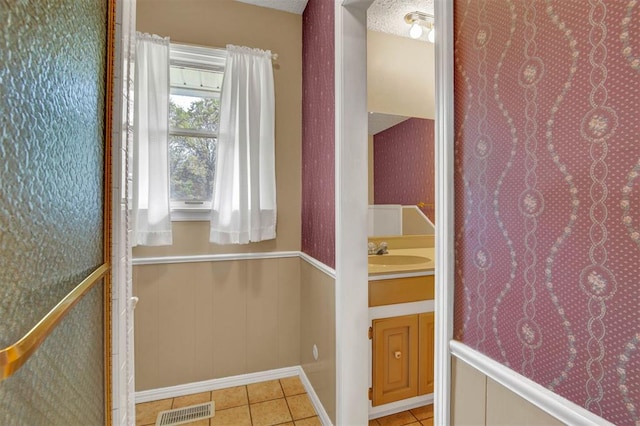 bathroom with tile patterned flooring and vanity