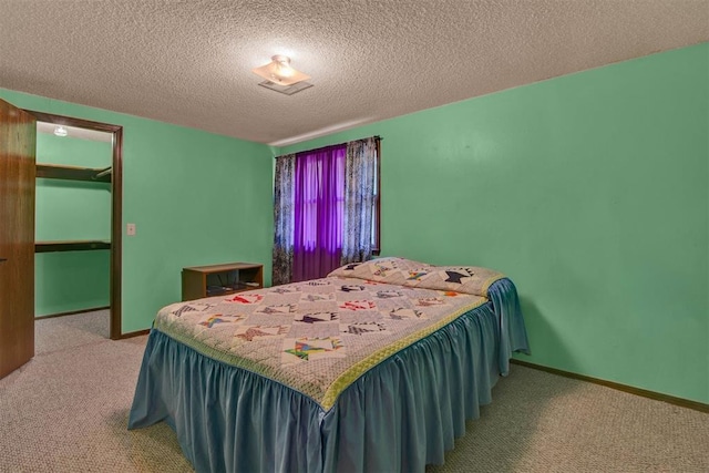 carpeted bedroom with a textured ceiling