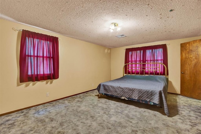 carpeted bedroom featuring a textured ceiling