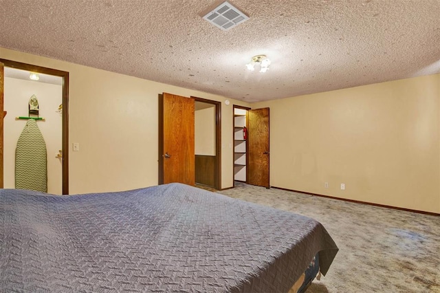 carpeted bedroom featuring a textured ceiling