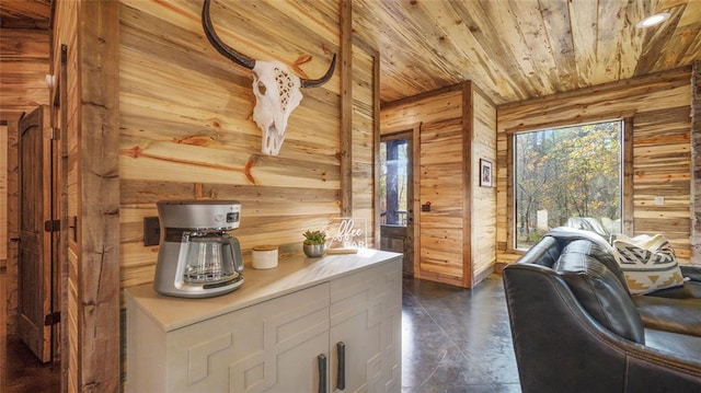 kitchen featuring white cabinetry, wooden walls, and wood ceiling