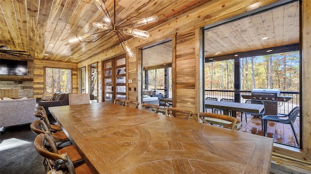 dining area featuring wooden walls, hardwood / wood-style floors, wood ceiling, and a notable chandelier