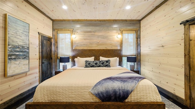 bedroom with wood walls, a barn door, and wood ceiling