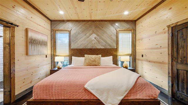 bedroom with multiple windows and wood walls